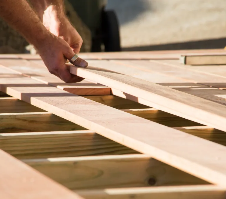Wood deck frame installation during backyard patio construction