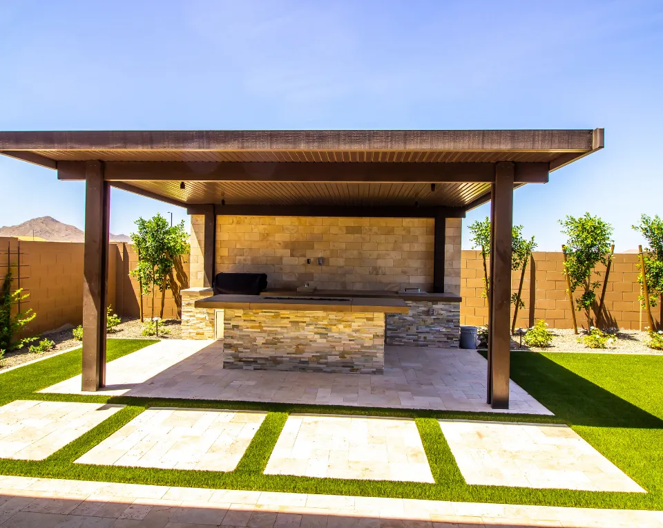 Paver patio installation in Los Angeles with outdoor kitchen, seating area, and structured hardscape design