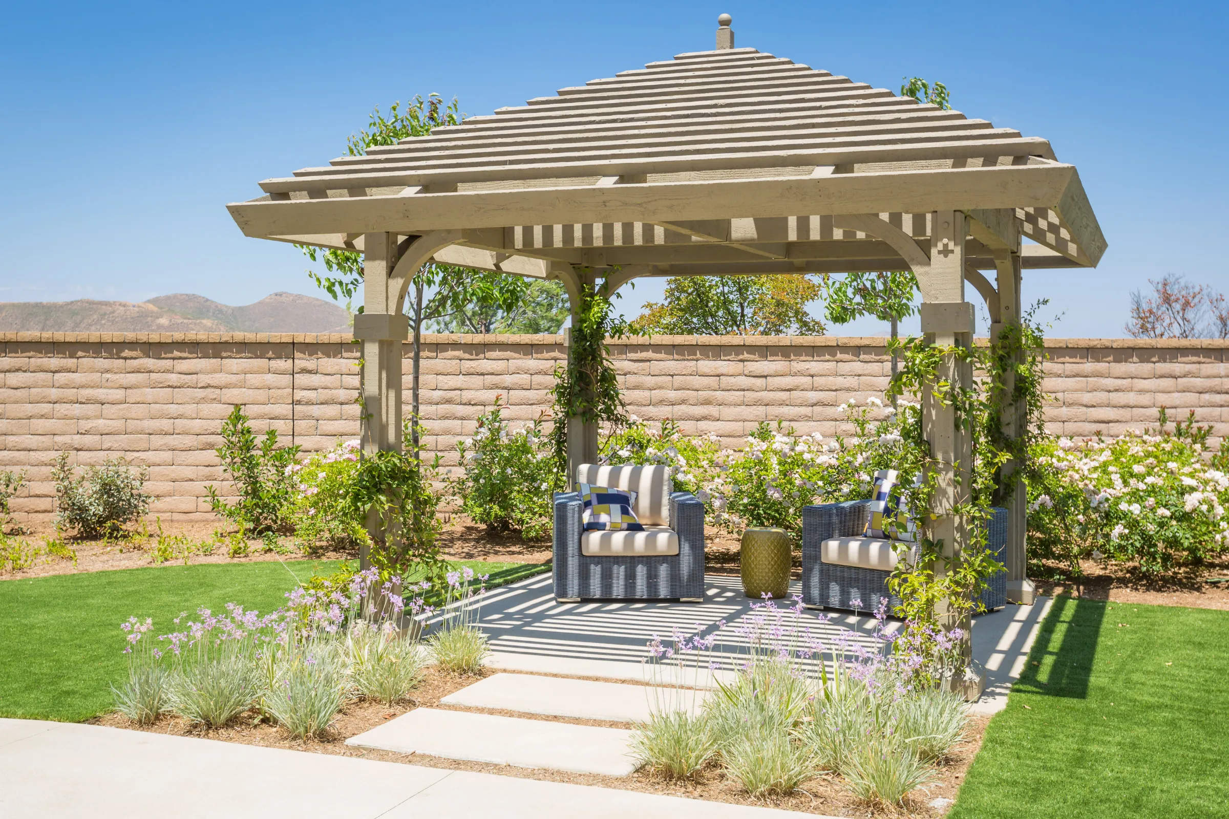 Pergola patio cover installation in Los Angeles with wood structure, shaded seating area, and landscaped backyard design