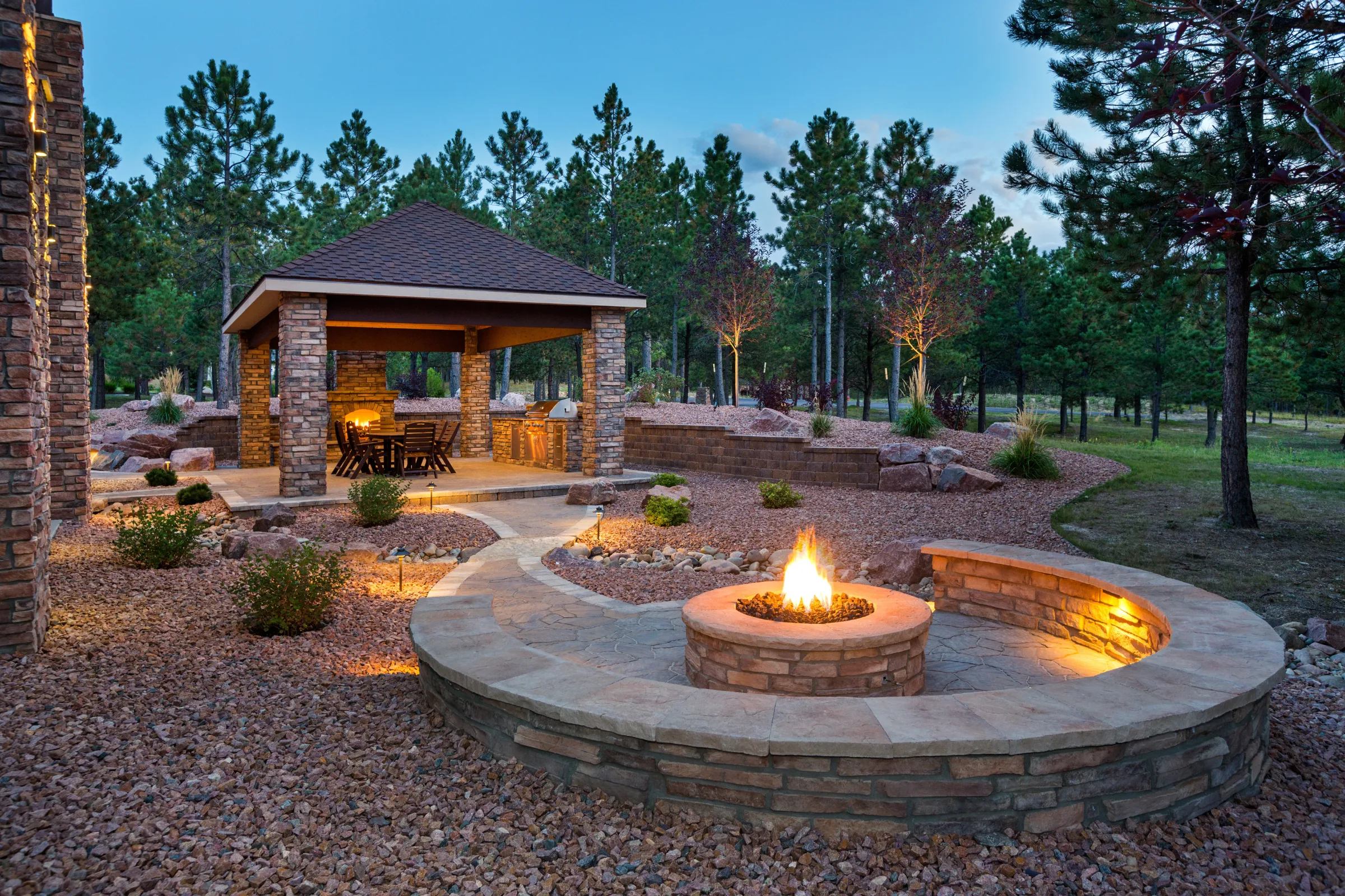 Patio cover and pergola in Los Angeles backyard with fire pit seating area and ambient string lighting